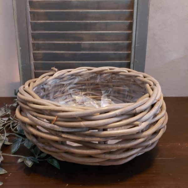 Ronde mand van rattan voor planten.